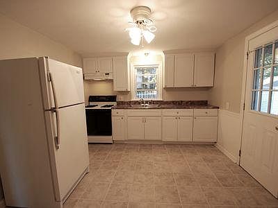 Kraftmaid Cabinets, Refrigerator, Stove, and Hood Range