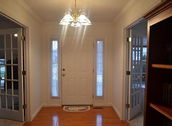 Entry foyer. to the left is the den/formal living room that is currently being used at a 6th bedroom and to the right is the the formal dining room that is currently being used as a sewing room