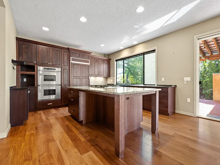 Kitchen with Built-in Refrigerator, two ovens, granite countertop