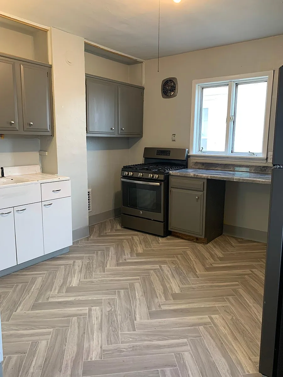 Kitchen, dishwasher, farmhouse sink and herringbone floor. - 76 Bradley St