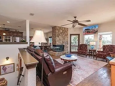 Living room great for family gatherings, opens to back porch with lake views and cool evening cross-breeze.