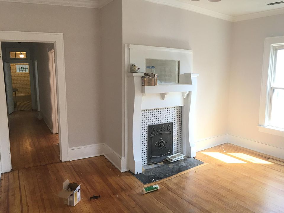The living room has a beautiful mirrored mantel and marble t
