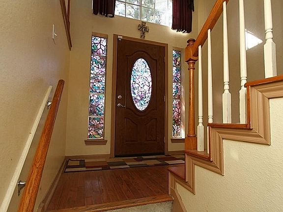 Leaded glass front door. Laminate wood landing at entrance. This is a split level, so from the landi