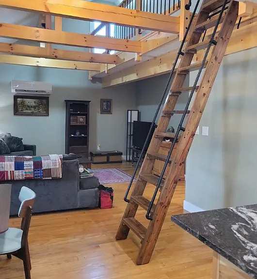 Open floor plan with hand hewn beams.