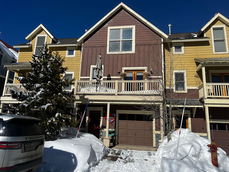 Front Townhouse View with Balcony and Garage.