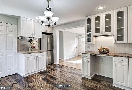 Spacious kitchen with breakfast nook leading to deck for an enjoyable indoor-outdoor dining experience