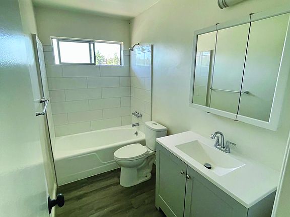 New Vanity, tile, hardwood floor laminate, fresh paint. Clean living.