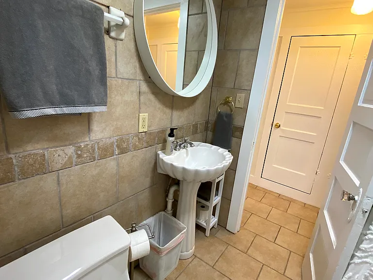 Downstairs bathroom with bathtub.