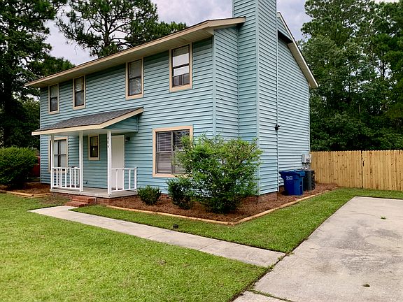 This is a side-by-side duplex. The entrance to 406 Lennon Drive is at the front center of the home.