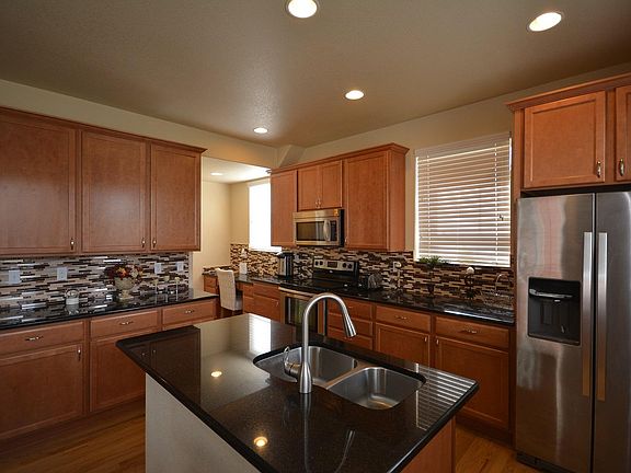 Kitchen with granite countertops, stainless steel appliances
