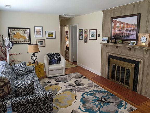 Front living room with gas fireplace and hardwood floors.