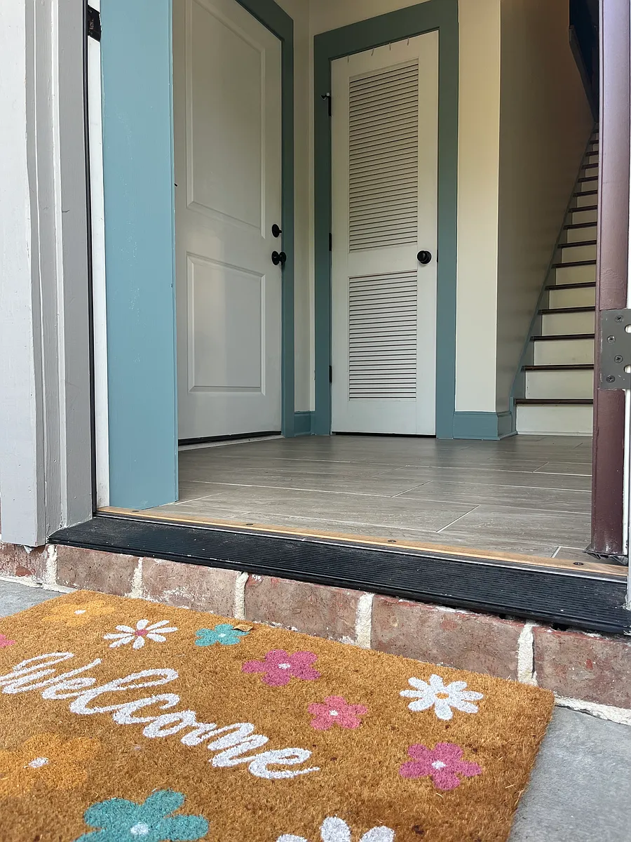 Entryway with coat closet, entrance to 2-car garage (on left) and staircase to main level. - 169 Slipper Shell Ct