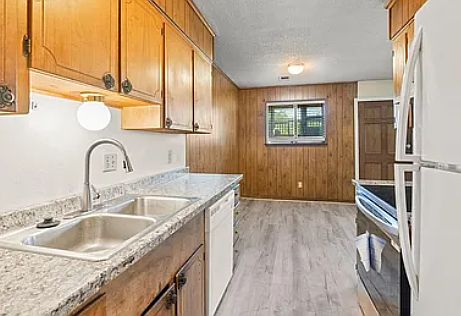 KITCHEN: New countertop, pull-down faucet, luxury glass-top self-clean electric range and stove, LVP floors, and heavy duty garbage disposal.