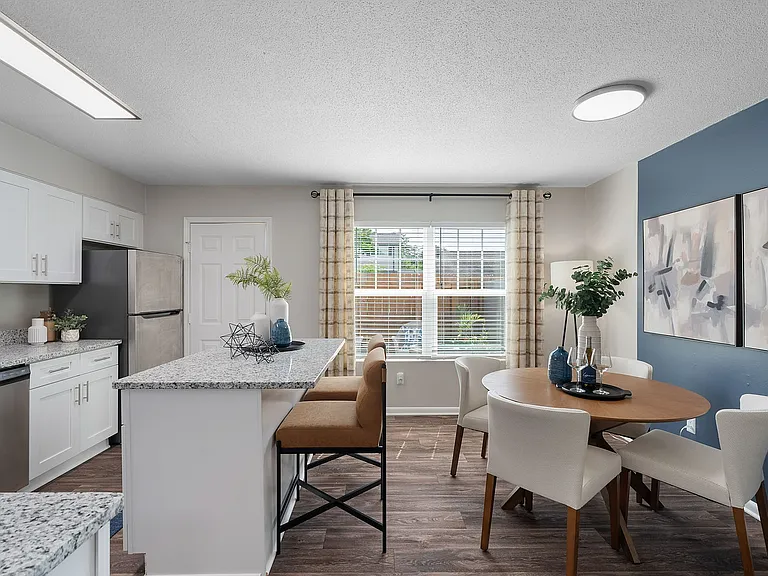 Kitchen and dining area with hardwood-style flooring