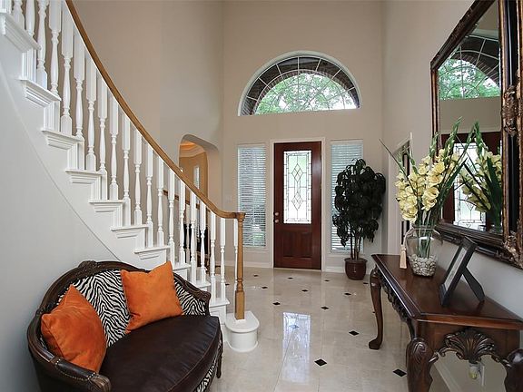 Foyer is not only Elegant but Functional with a Large Under Staircase Storage Closet.