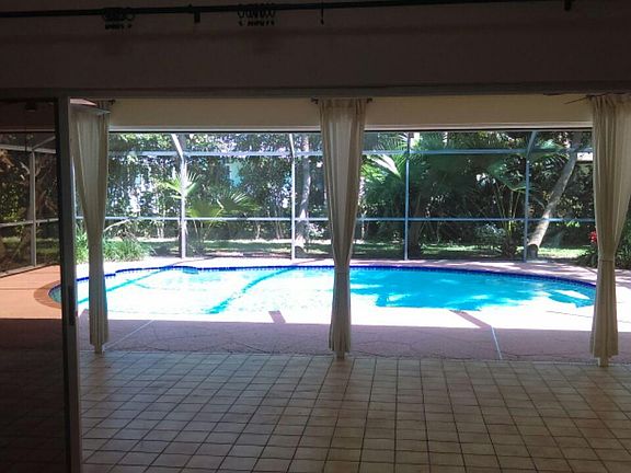 The great room looks out over total pool and patio