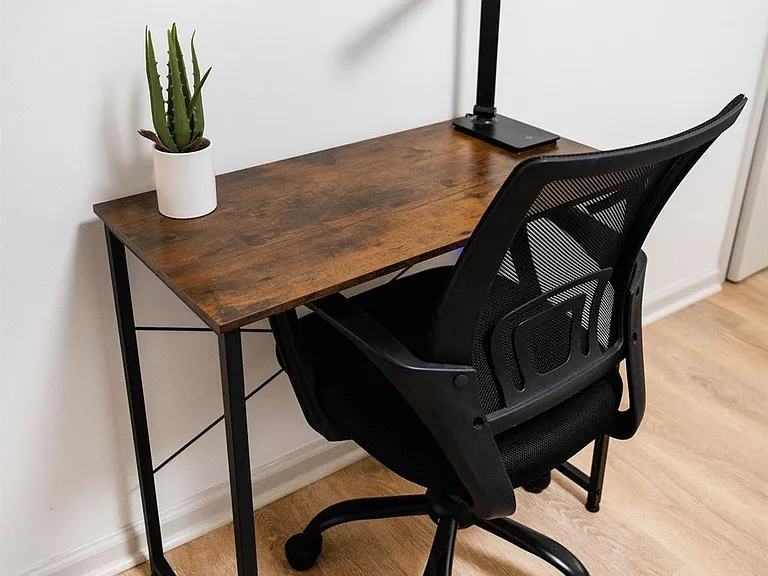 Dedicated work nook with a writing desk, task lamp, and rolling chairideal for studying or remote work.