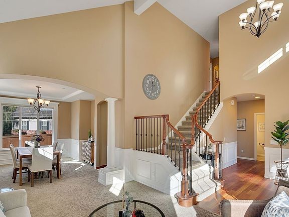 Wrought iron staircase meets soaring high ceilings.