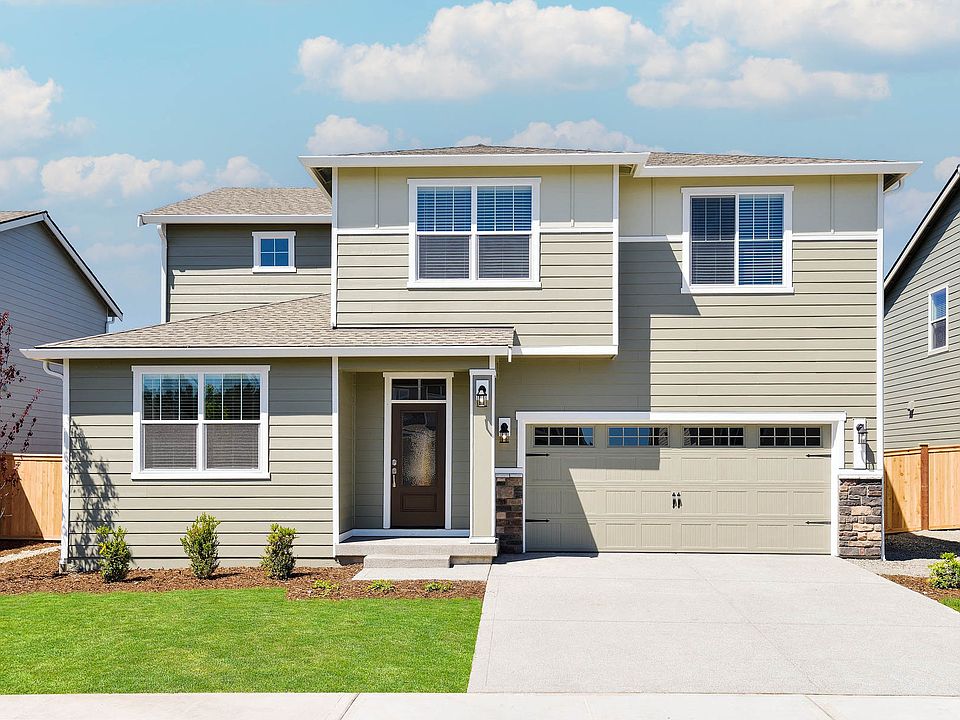 Beautiful two story home at Prairie Creek Farms with siding and stone and front yard landscaping