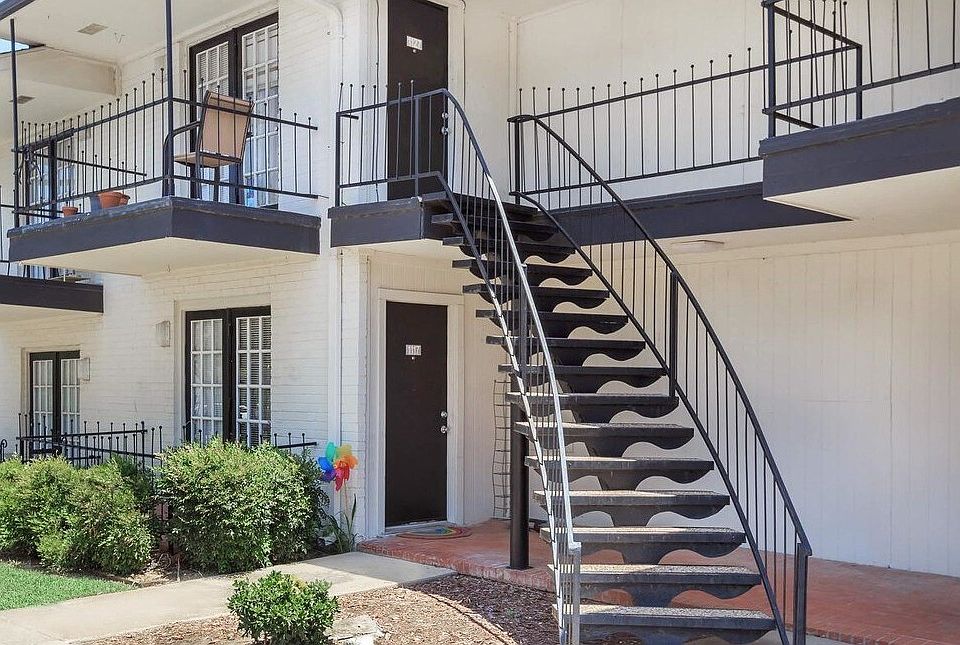 Charming exterior design featuring private patios and balconies surrounded by beautiful landscaping.