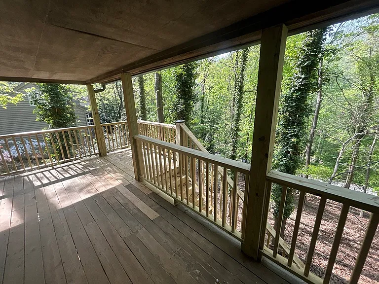 To the left, you can see the woods and the newly-renovated stairs down to the back yard. The newly-constructed stairs will be stained after the wood acclimates to the environment.