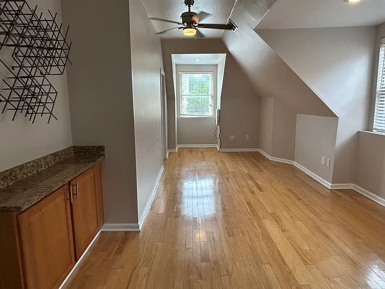 Living space with granite bar and wine storage.