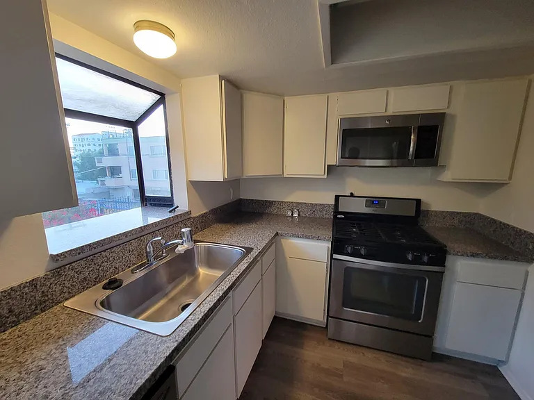 Kitchen: Granite Countertop, Dishwasher, Stainless Steel Sink w Garbage Disposal, Stove, Microwave & Lots of Cabinets