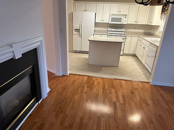 Kitchen leading into the dining room with gas logs
