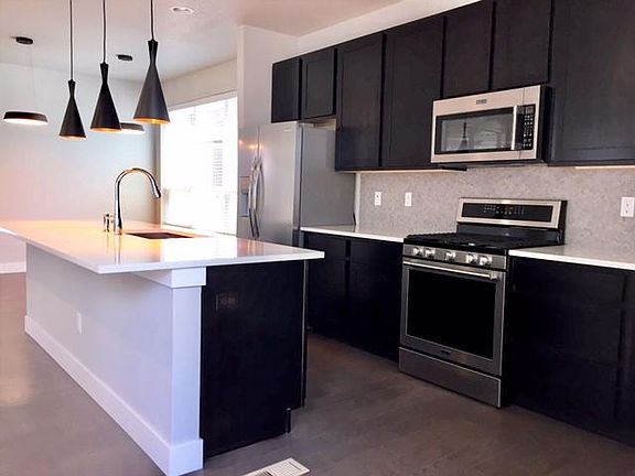 kitchen with custom quartz surface, glass backsplash,