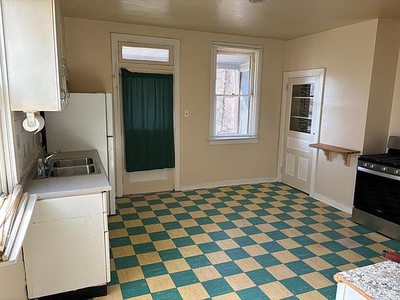 Kitchen -door leading to back deck and yard. New windows to be installed in late May
