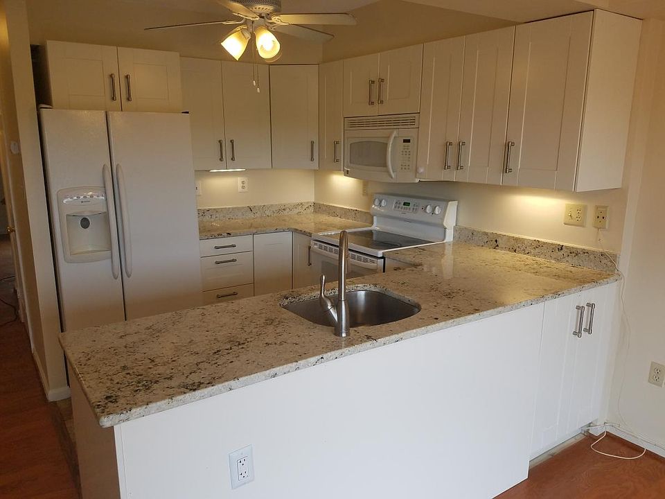 Remodeled kitchen with granite counters and under-cabinet lights