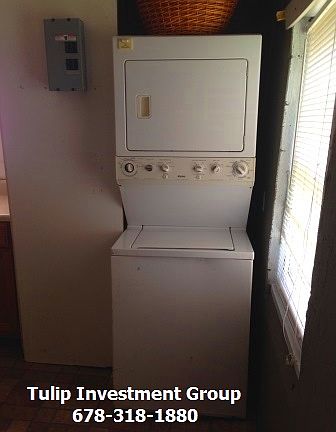 Stacked washer and dryer included.