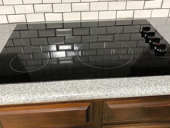 The kitchen is newly remodeled and has an electric, glass cooktop and built-in oven, stainless dishwasher and sink. The kitchen has a large pantry closet with ample shelving.