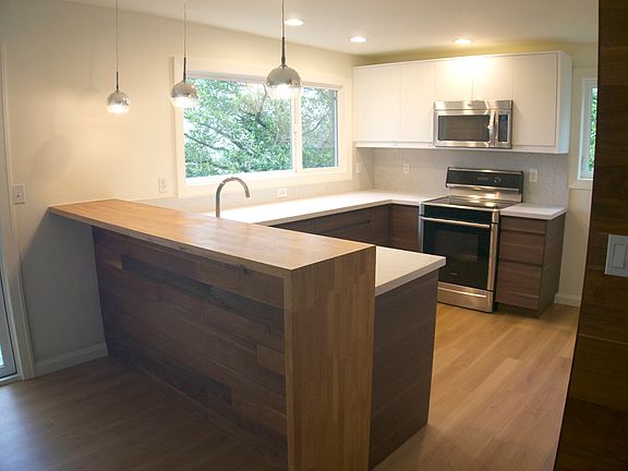 Chef's kitchen with tons of counter space, great natural light, newer appliances including quiet dishwasher, and brand new cabinets and quartz counters. Full height cabinets (shown on plan) provide ample storage with a 36" wide fridge.