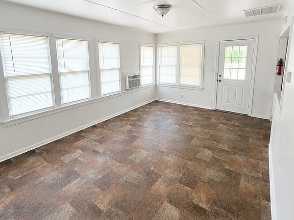 Bright & Spacious Living Room with plenty of natural light and room for comfortable seating.