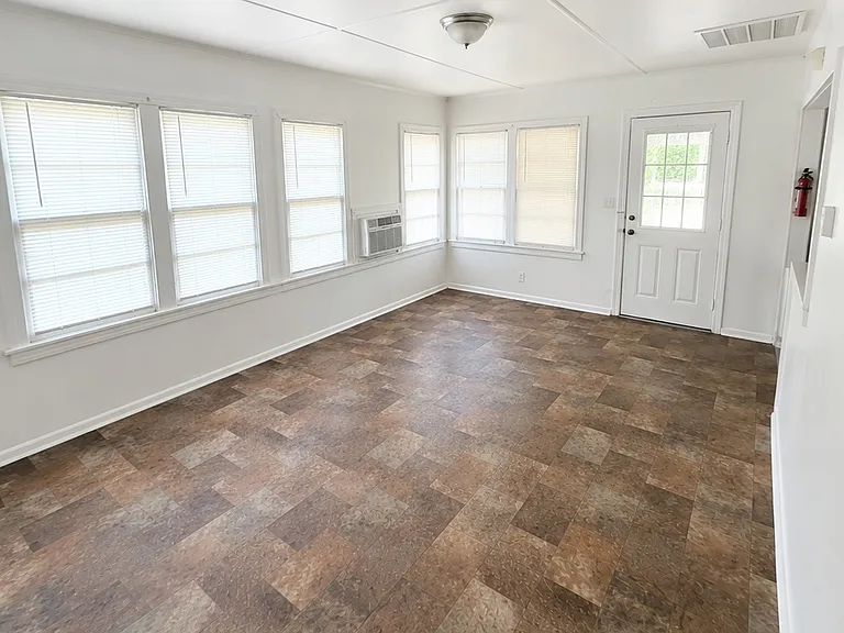 Bright & Spacious Living Room with plenty of natural light and room for comfortable seating.