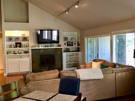 Spacious living area with vaulted ceilings and fireplace.