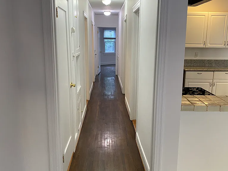 Extra Long Hallway Leading To Bedrooms and Bathrooms