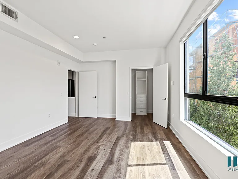 Master Suite with Large-Size Windows, Vinyl Flooring, Recessed Lighting, and Walk-In Closet