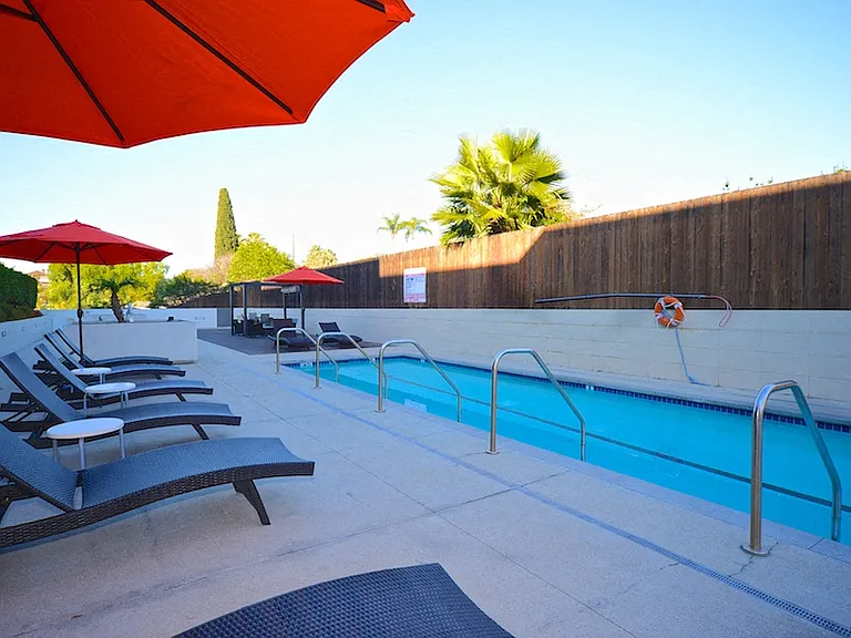 Plenty of chaise lounge chairs and umbrellas on the sun deck at 12th Street Lofts in National City, California.