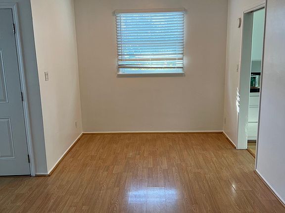 Dining Room and Door to Kitchen. Window has a window AC included.