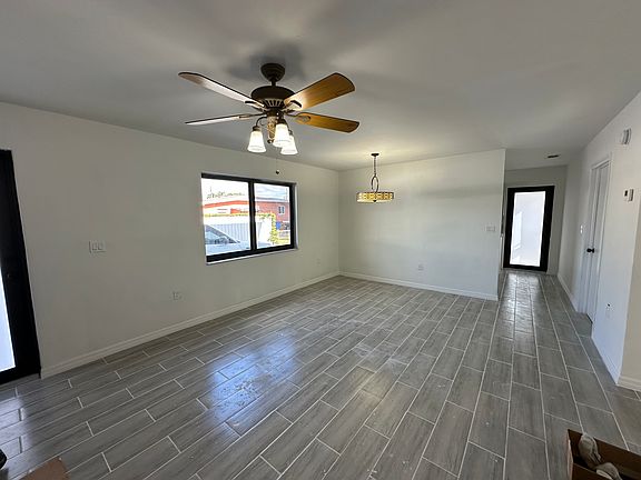 Large Living Room with New Ceramic Flooring and Ceiling Fan 
Impact Windows and Doors