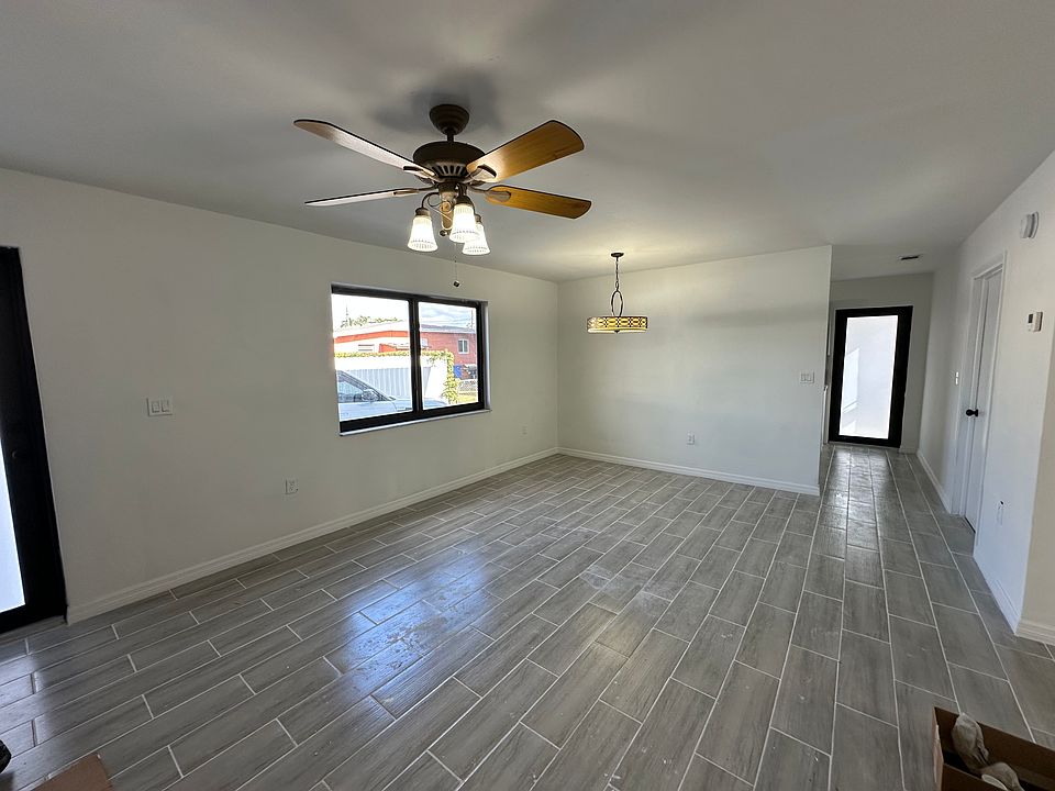 Large Living Room with New Ceramic Flooring and Ceiling Fan 
Impact Windows and Doors