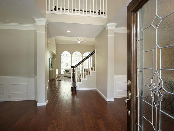 Upon entering the home your eyes are immediately drawn through the home to the back yard via the triple arched windows at the back of the home. To the left is the Study/Formal Living and to the right is the Formal Dining Room.