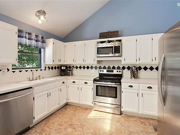 So much space in this Kitchen!  No worries for storage with plenty of cabinets & counters.  Freshly painted cabinets; gorgeous SS appliances