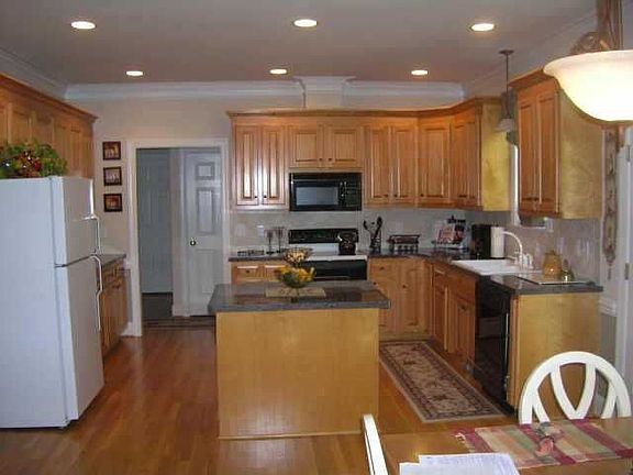 Large kitchen w/silestone countertops & center island features electric range 
