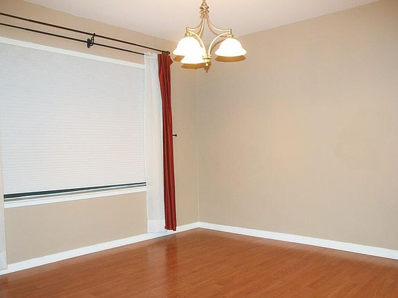 Bright dining room with large window and next day blinds