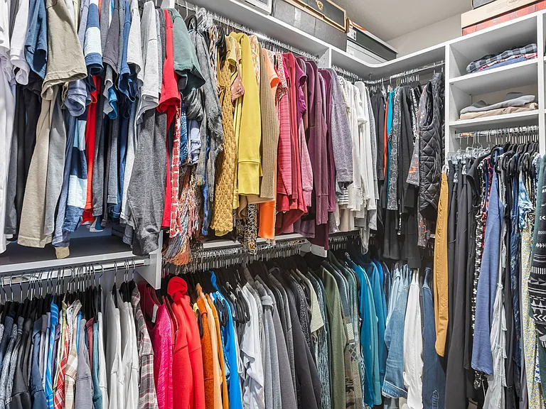 Primary Bedroom walk-in closet w/built-in ironing board.