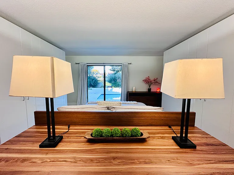 Master bedroom offers the ultimate blend of comfort and function, featuring a dedicated workspace with a generous executive-style table.