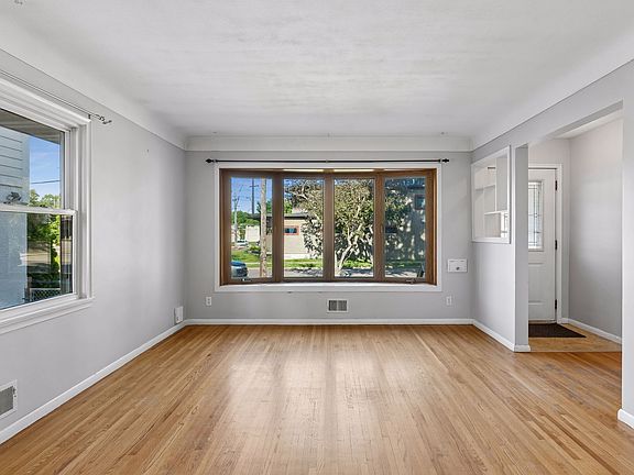Main floor living room with two big windows for all the natural lighting